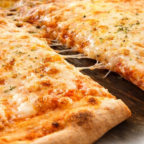 A cheesy slice of Grace's Place Pizzeria pizza being pulled from the pie, stretching the cheese.